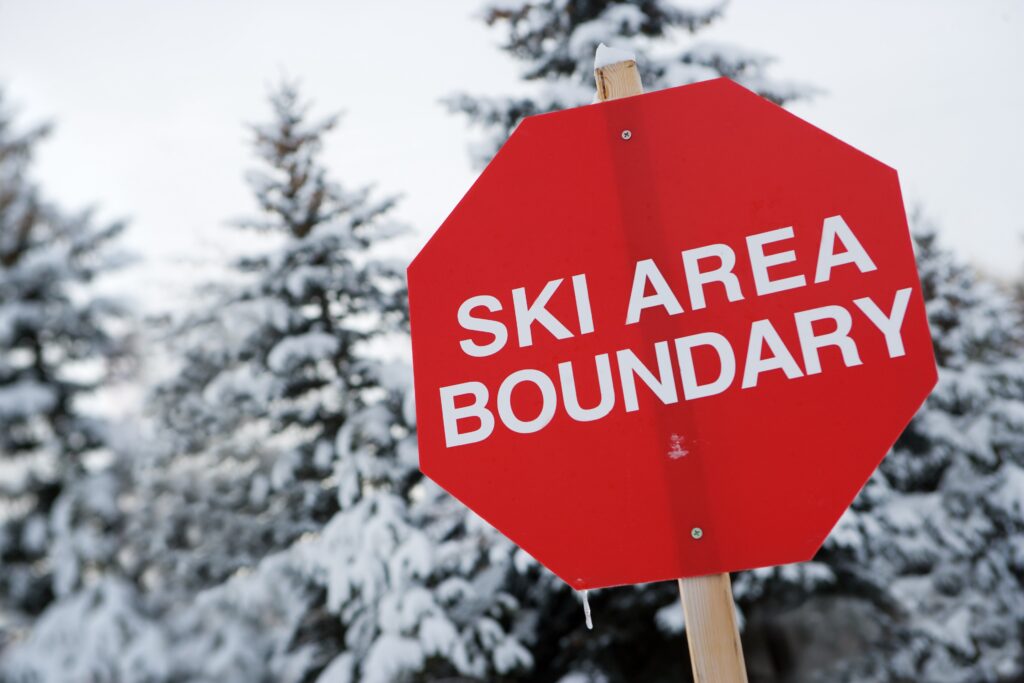 Ski Area Boundary sign shaped as a stop sign, warning skiers that they have reached the end of the ski area which is patrolled by ski patrol. Steamboat Ski Resort Unveils New Terrain & Safety Code Reminder